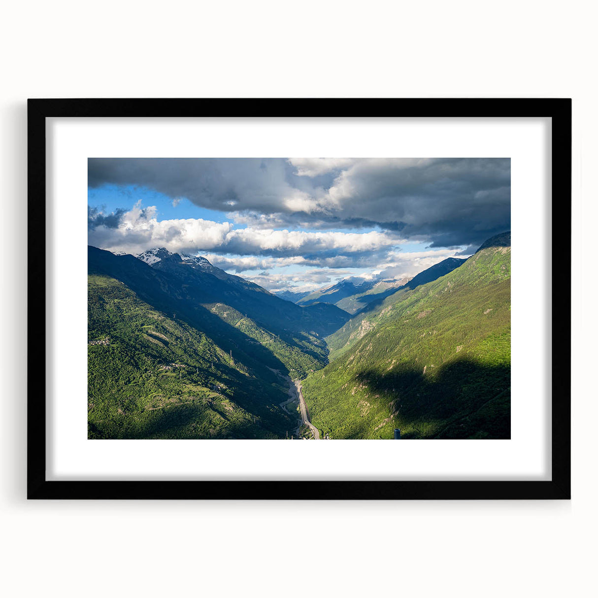 Black-framed wall art featuring a serene valley landscape with vibrant colors, ideal for home decor, showcasing nature's beauty in a modern design.