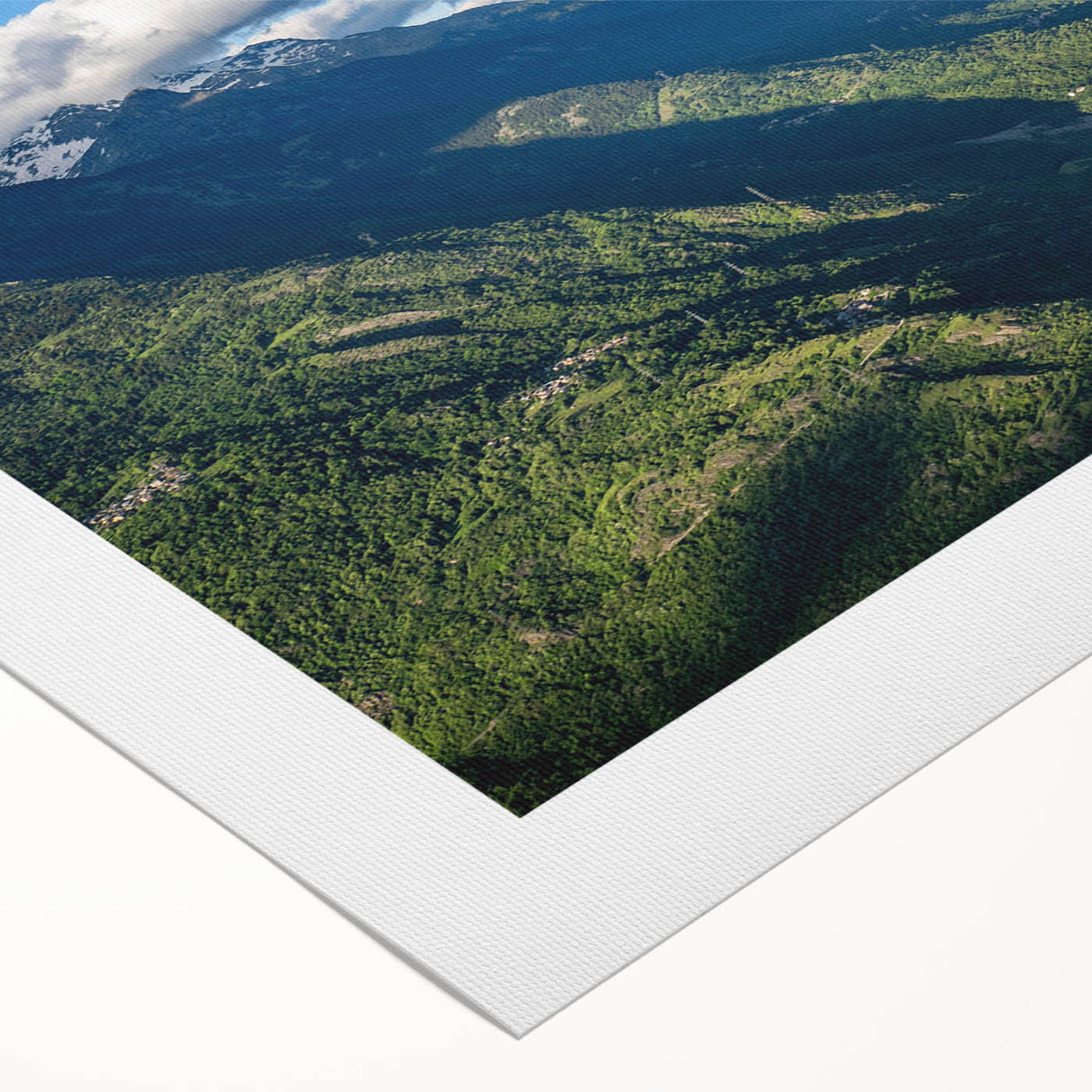 Rolled canvas wall art showcasing a vibrant landscape of a serene valley, featuring rich greens and blues, perfect for adding a natural touch to home decor.