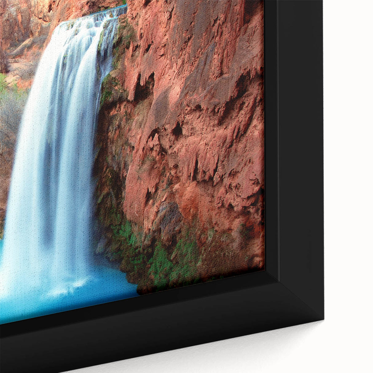 Framed canvas artwork showcasing a vibrant waterfall landscape, with lush greenery and cascading water, perfect for home decor or nature-themed interiors.