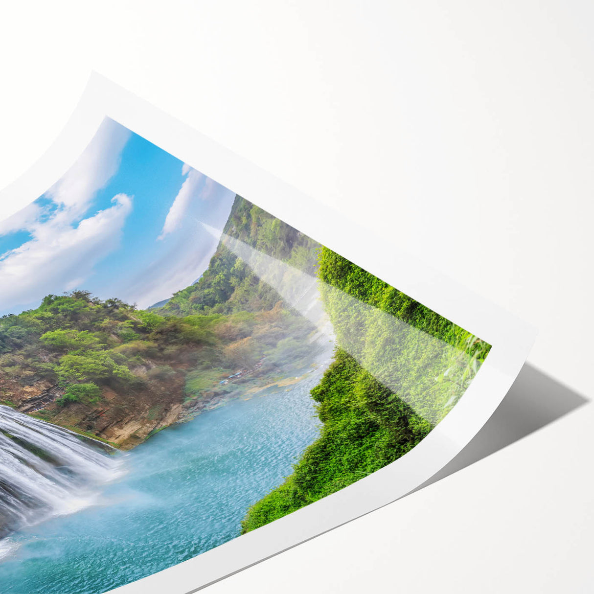 Vibrant rolled print showcasing a serene waterfall landscape, featuring lush greenery and cascading water, perfect for enhancing home decor with a natural touch.