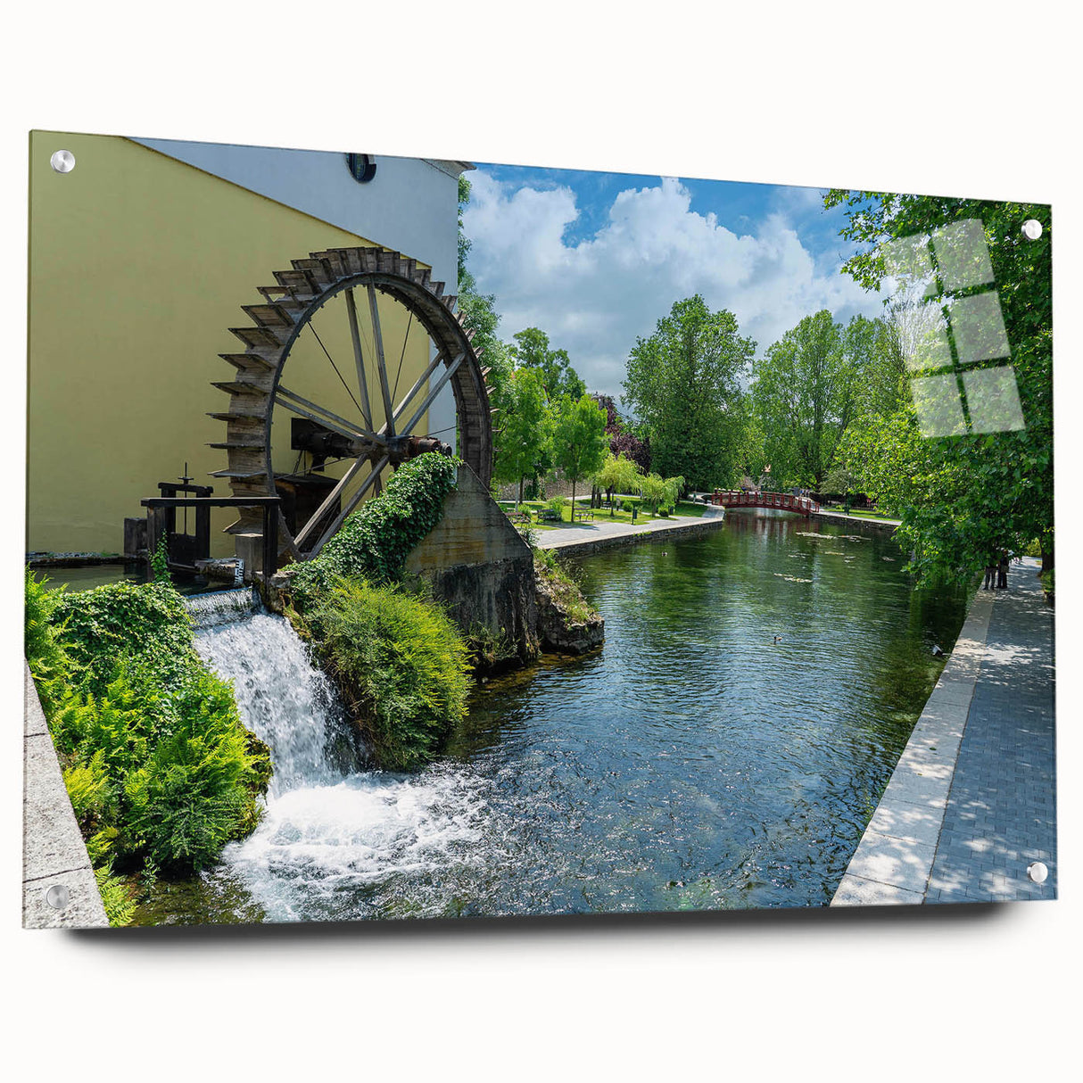 Acrylic glass wall art showcasing a stunning landscape of watermills, framed in a modern design with visible mounting pins, perfect for enhancing home decor.