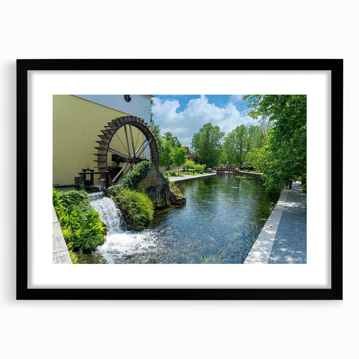 Framed wall art depicting a serene landscape with watermills, featuring a black mat and frame, perfect for enhancing home decor with nature-inspired aesthetics.