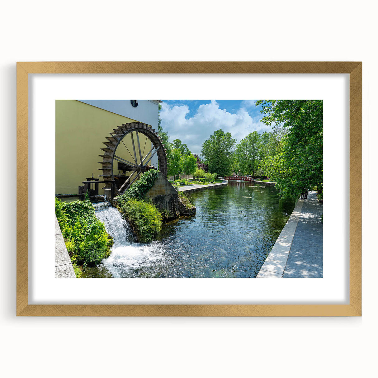 Elegant wall art collection featuring a gold-framed landscape design of serene watermills, with a white mat accentuating the artwork, ideal for home decor.