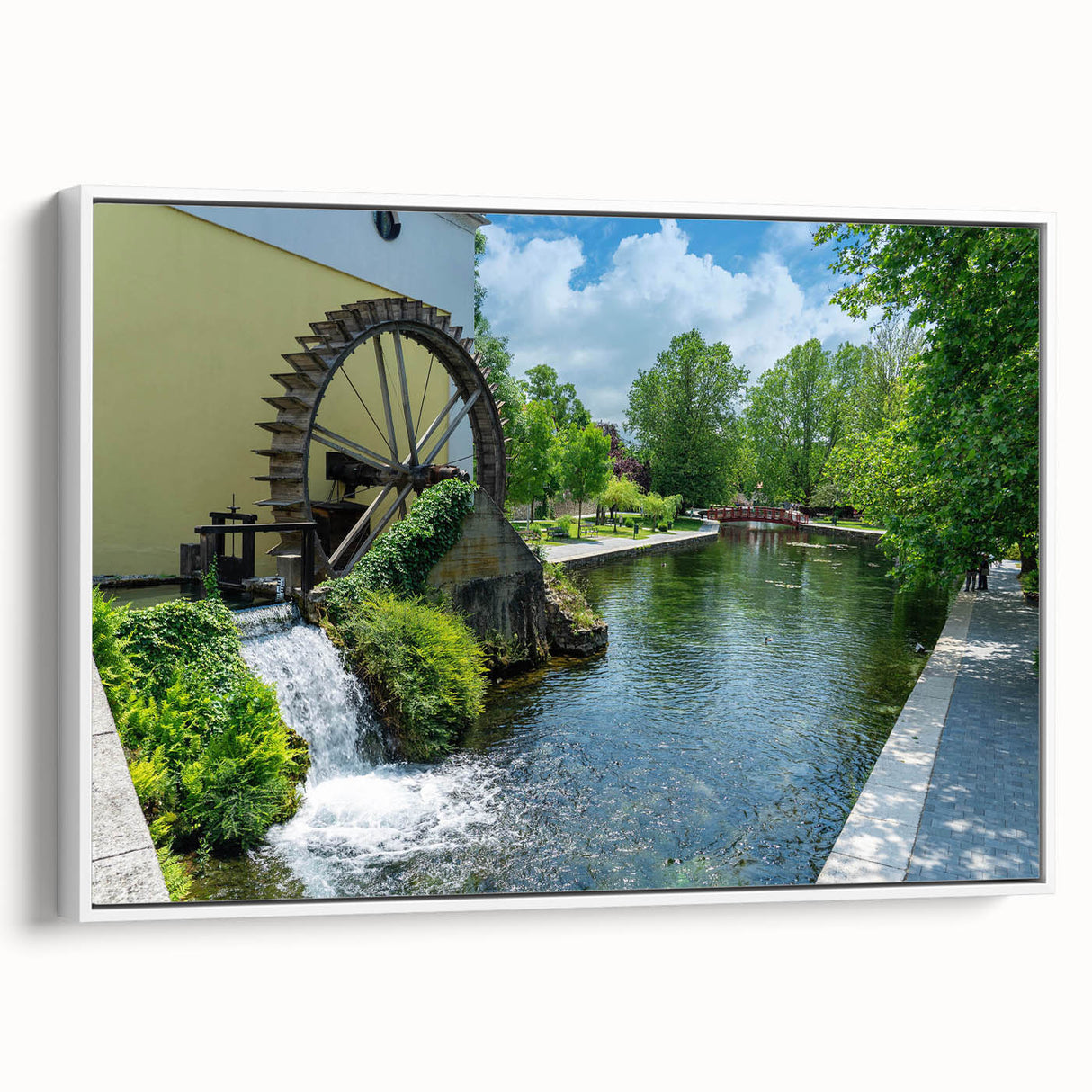 Framed canvas wall art showcasing a serene landscape of a watermill, featuring soft colors and intricate details, displayed in a stylish white frame. Ideal for enhancing home decor.
