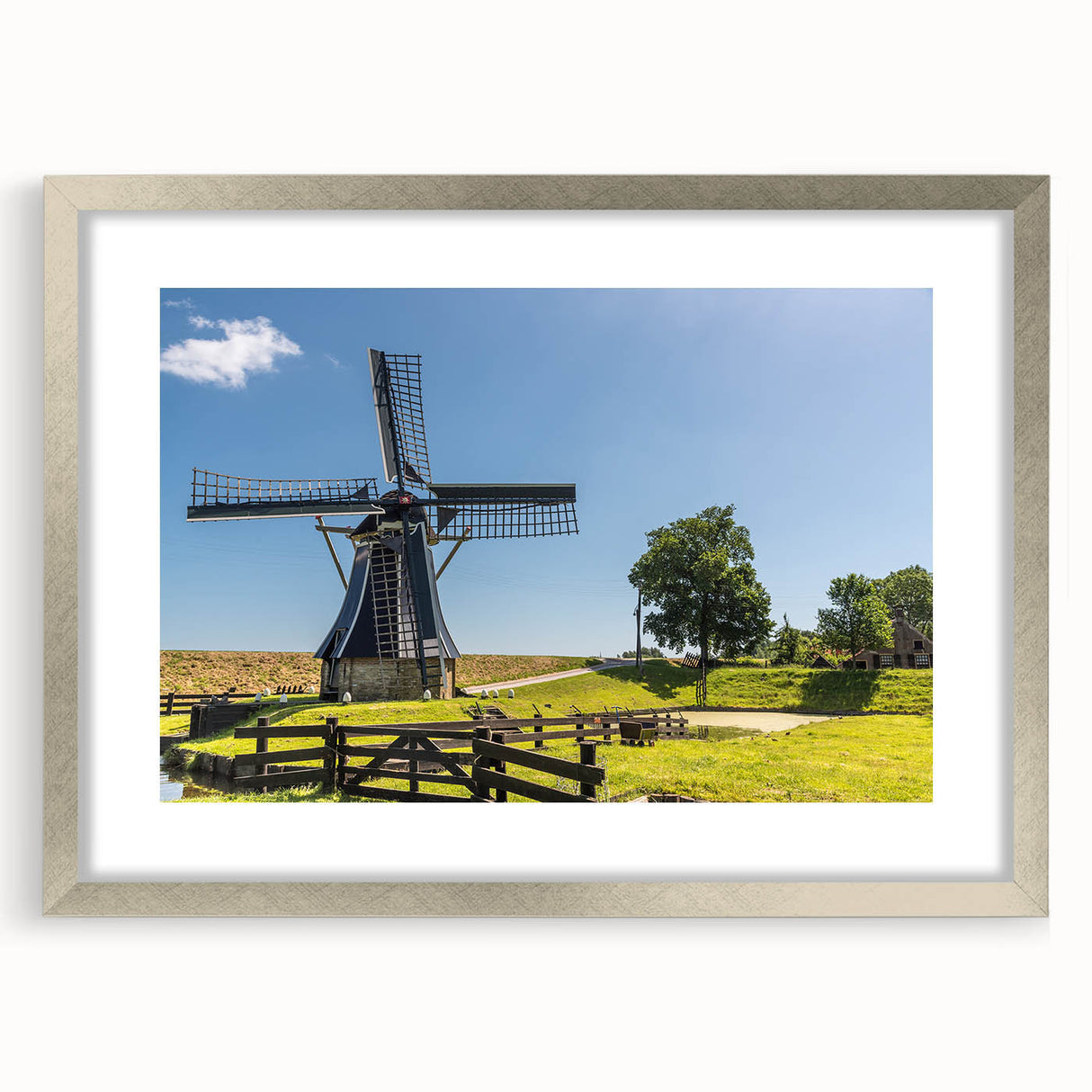 Framed wall art featuring a serene landscape with windmills, presented in a silver frame with a mat, ideal for modern home decor. Perfect for adding elegance to living spaces.