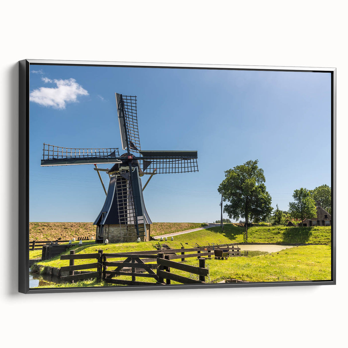 Framed canvas wall art featuring a serene landscape with windmills, showcasing vibrant greens and blues, ideal for home décor and artistic ambiance.