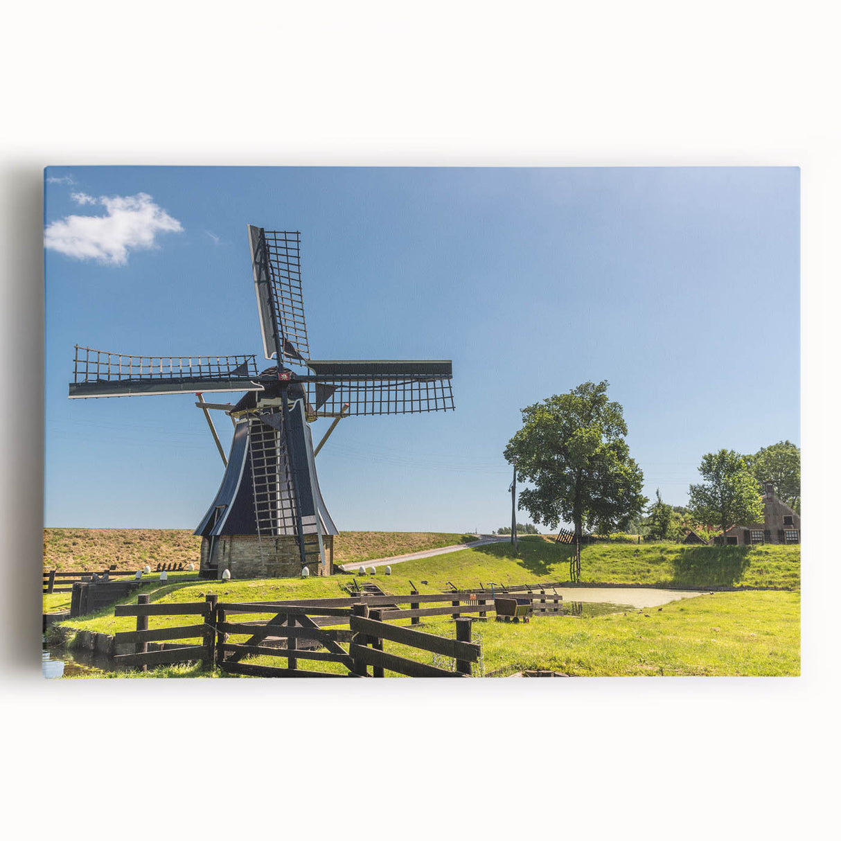 Stretched canvas wall art showcasing a picturesque landscape with windmills against a vibrant sunset, ideal for enhancing home decor with a touch of serenity.