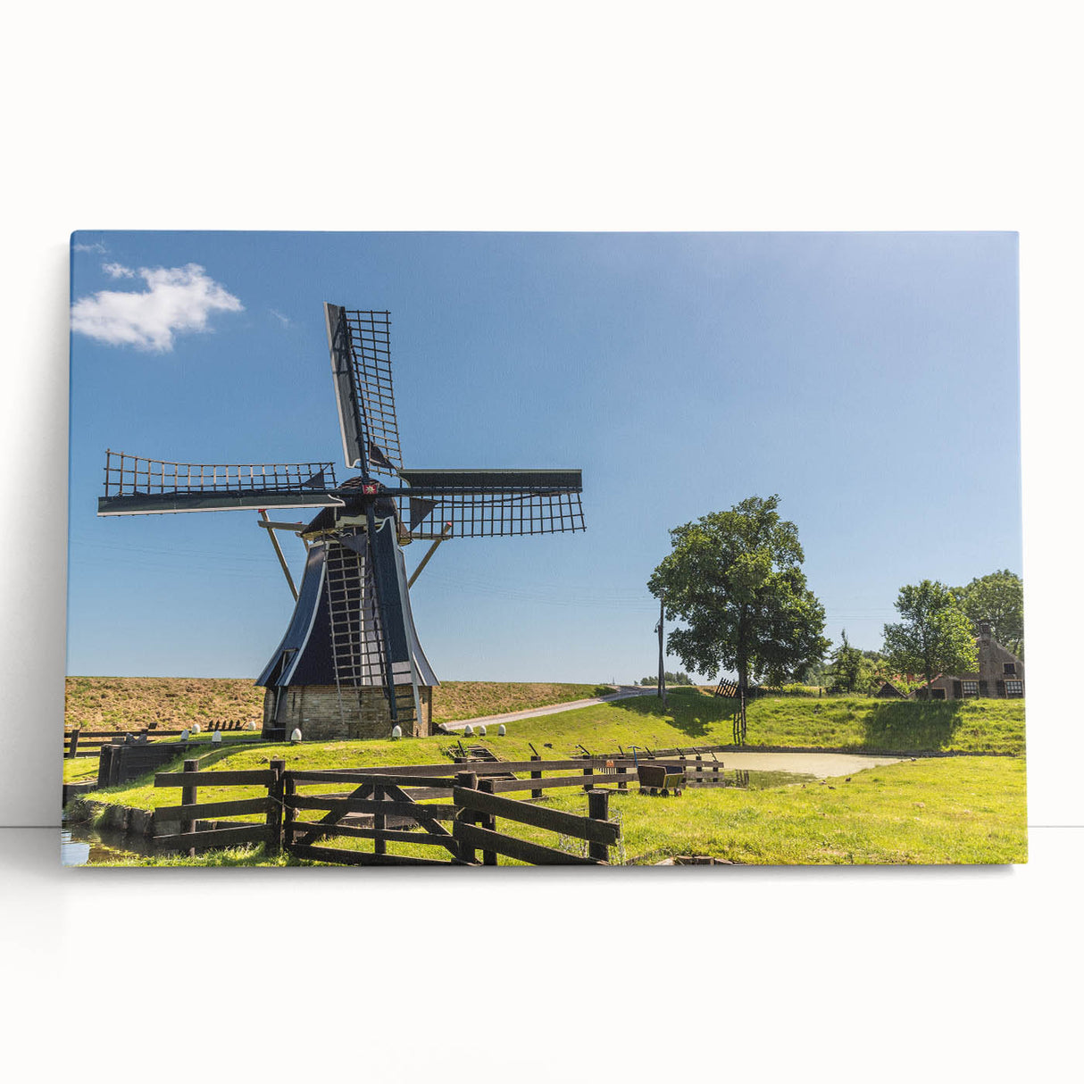 Stretched canvas wall art featuring a serene landscape with windmills against a vibrant sunset, ideal for home decor. Perfect blend of nature and tranquility.