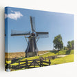 Stretched canvas wall art showcasing a serene landscape with windmills, featuring vibrant colors and intricate details, perfect for home decor.