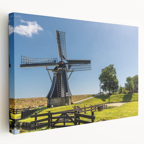 Stretched canvas wall art showcasing a serene landscape with windmills, featuring vibrant colors and intricate details, perfect for home decor.