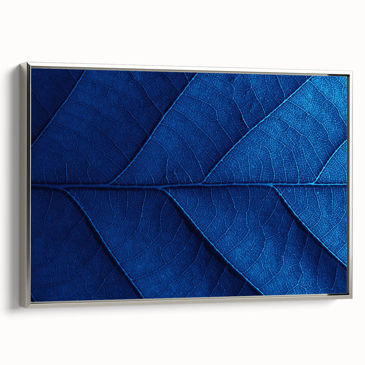 Framed canvas featuring a landscape art painting with colorful floral designs on a black background.