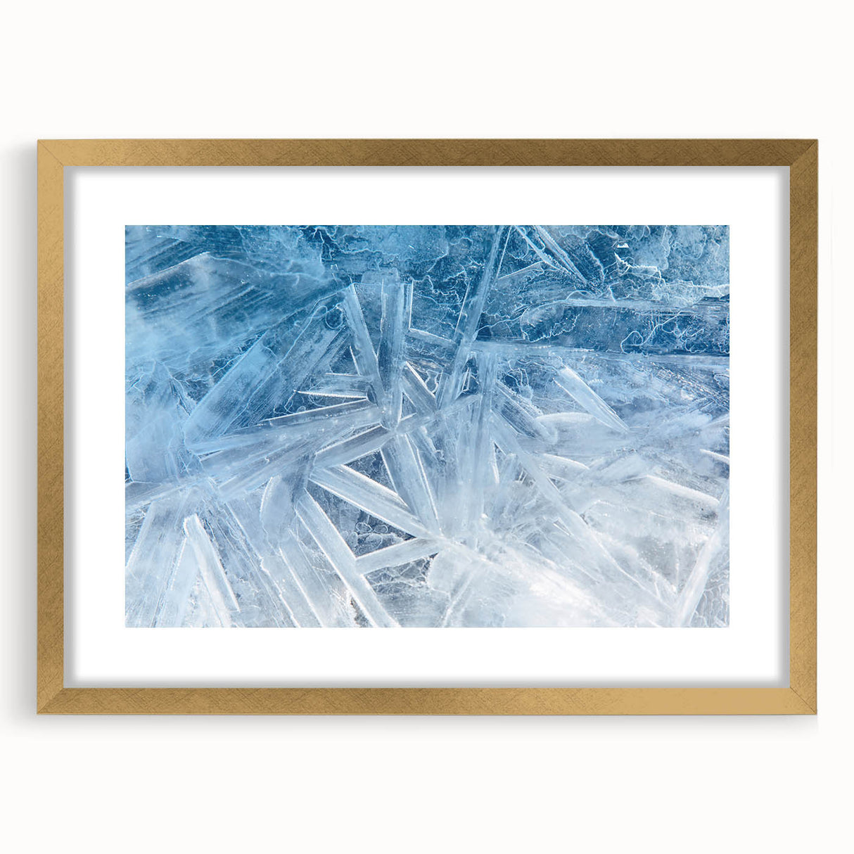 Textured art featuring abstract frost patterns in white and blue, framed in gold, ideal for bedroom art.