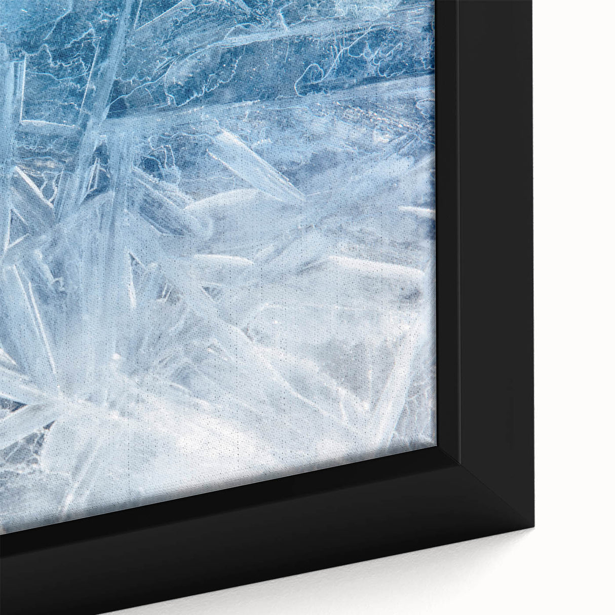 Close-up of black wall art featuring a textured frost design on framed canvas, ideal for living room decor.
