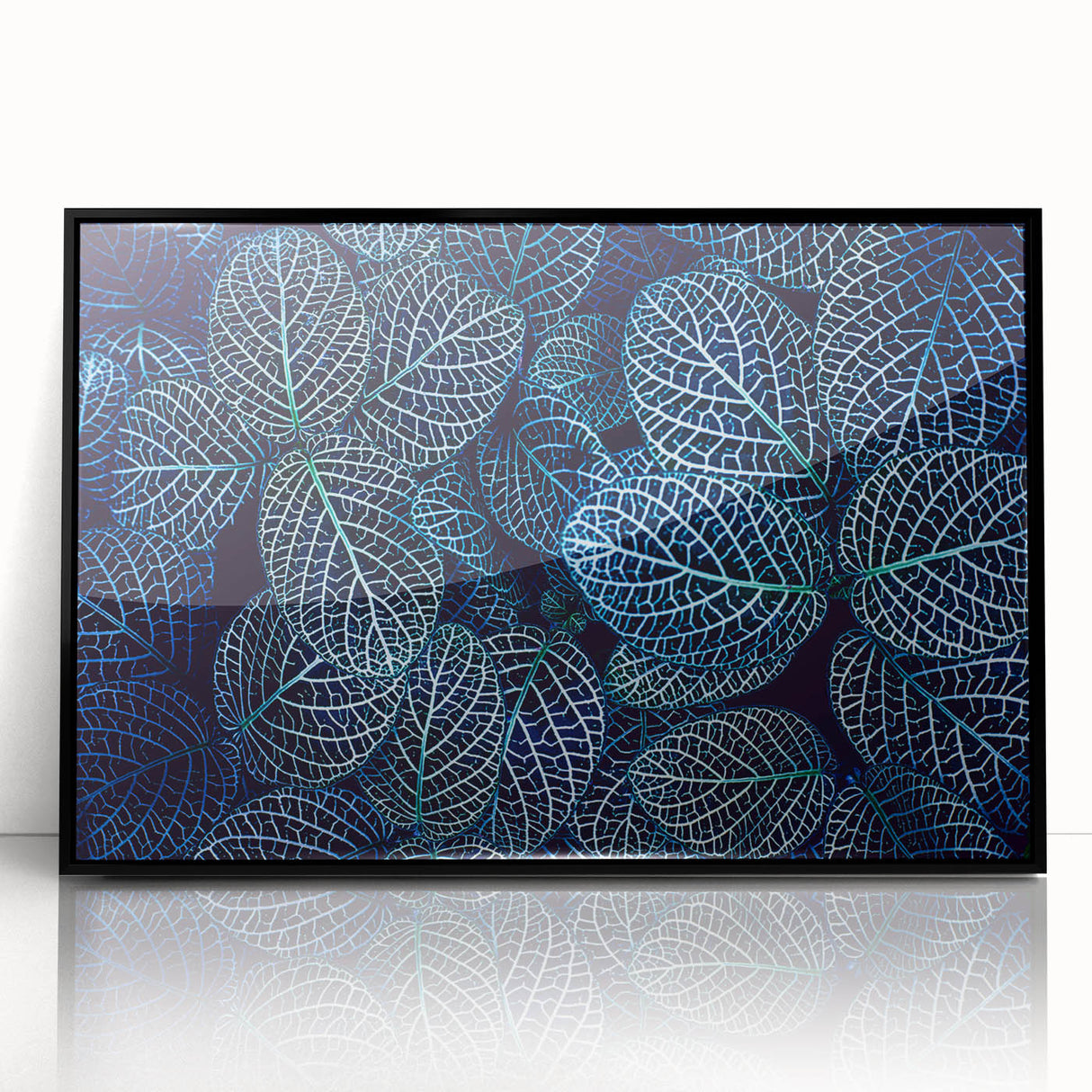 Large abstract wall art featuring close-up leaves in green and yellow tones on black acrylic, framed.
