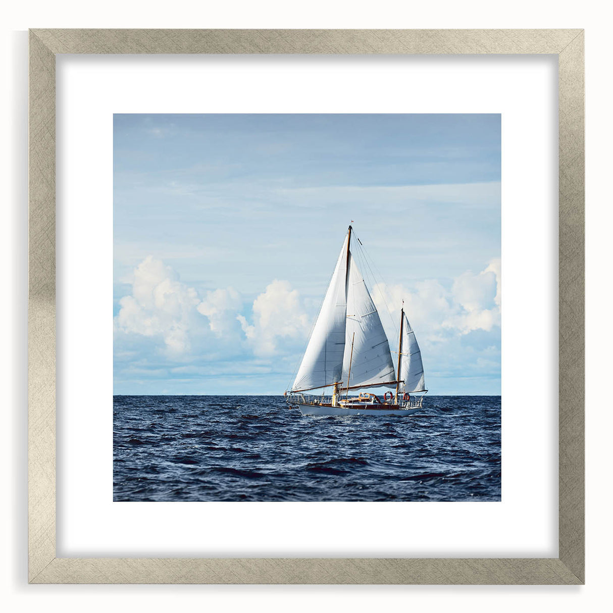 Abstract art print of a sailboat in muted blue and white tones on a framed silver mat.