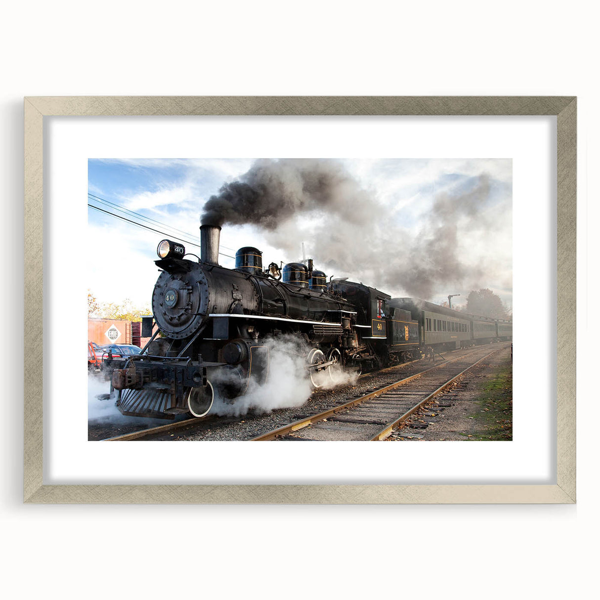 Textured abstract art print of a stylized train in muted grays and blues, framed in silver, ideal for bedroom art.