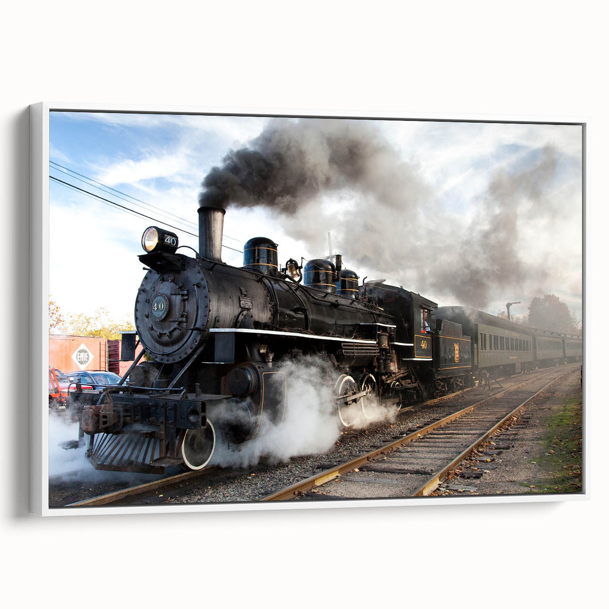 Vintage poster art of a colorful train on a black background, printed on a large framed canvas, ideal for living room decor.