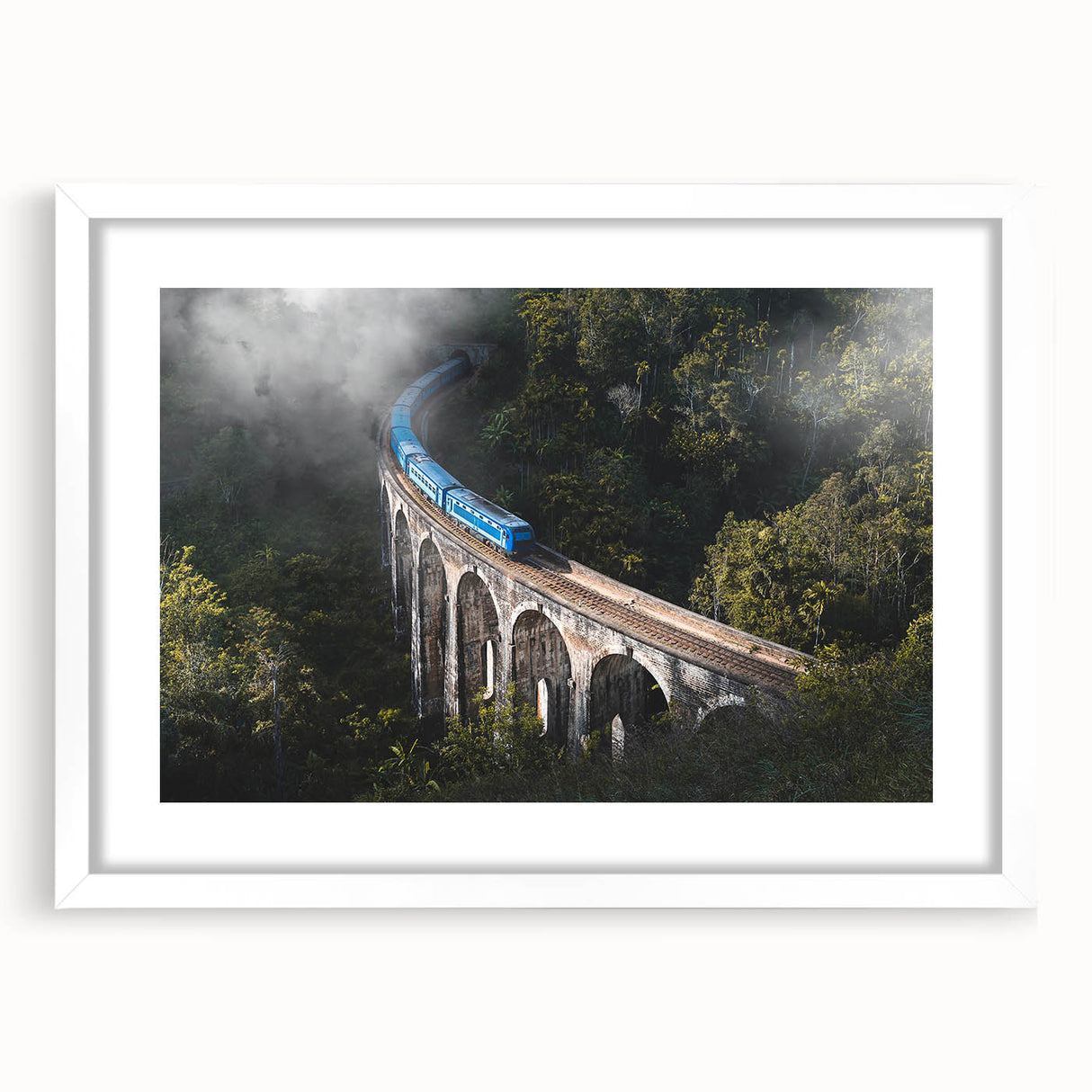 Abstract art print of a stylized train in muted gray and blue tones on a white-framed canvas.