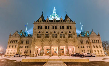 Evening view of a symmetrical, classical medieval palace, a landmark in Connecticut