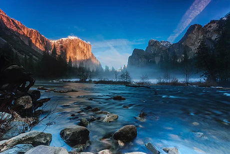 Stunning wall art featuring Yosemite National Park's mountainous landscape, blue skies, and serene body of water.