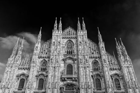Black and white monochrome photography of medieval cathedral, showcasing historic architecture and spire.