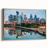 Landscape painting of a serene lake at sunset in muted orange and blue tones on a rolled canvas.