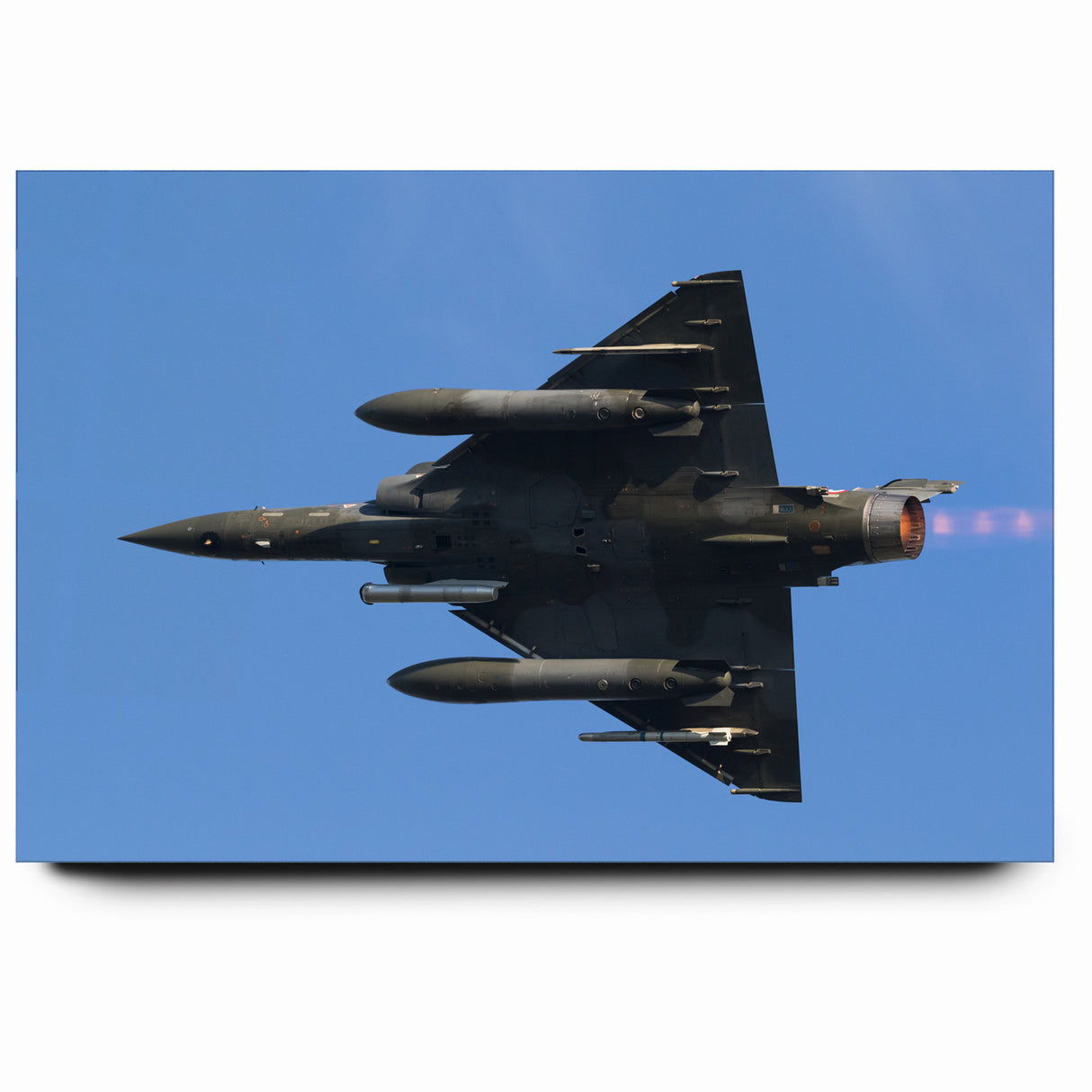 Modern Aviation Art: Fighter Jet in Flight Against Blue Sky Canvas Print