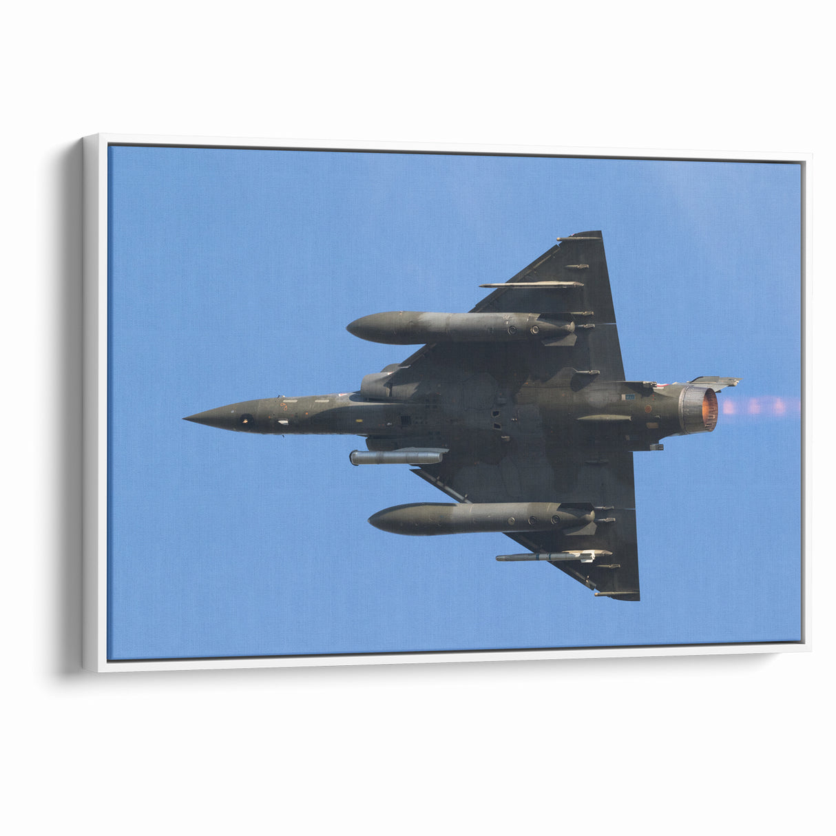 Modern Aviation Art: Fighter Jet in Flight Against Blue Sky Canvas Print