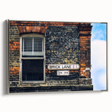 Framed canvas featuring a landscape art painting with colorful, vintage-style elements on a black background.