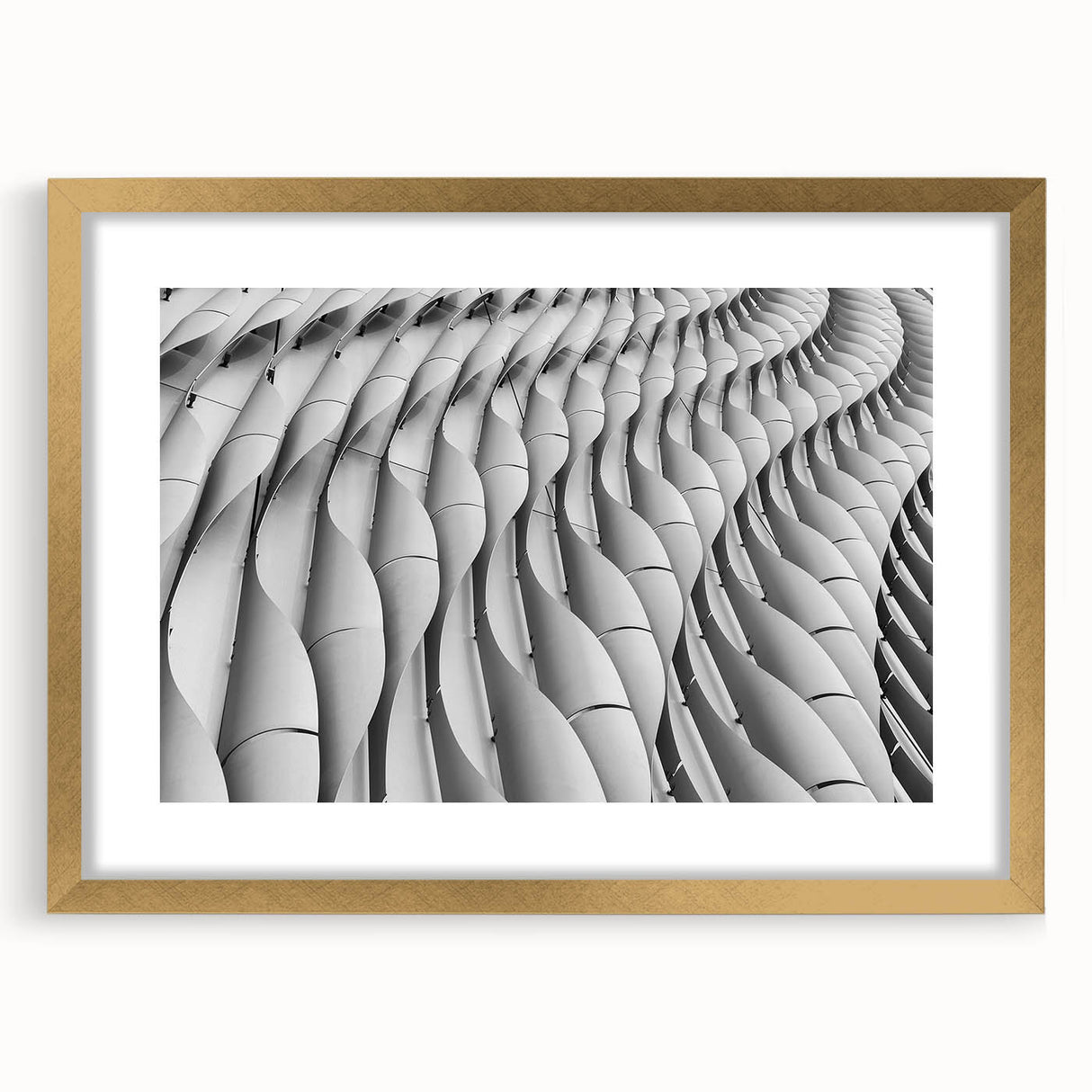Textured abstract art print in muted gold and beige tones on a framed canvas, suitable for bedroom decor.