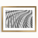 Textured abstract art print in muted gold and beige tones on a framed canvas, suitable for bedroom decor.