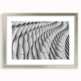 Abstract art print featuring swirling blue and gray tones on a framed canvas, suitable for dining room or bedroom decor.