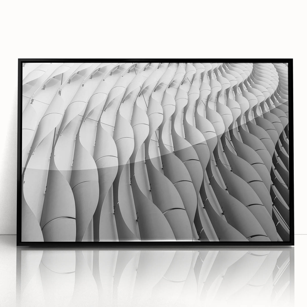 Large abstract wall art print featuring swirls in muted gray and blue tones on a framed acrylic.