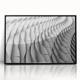 Large abstract wall art print featuring swirls in muted gray and blue tones on a framed acrylic.