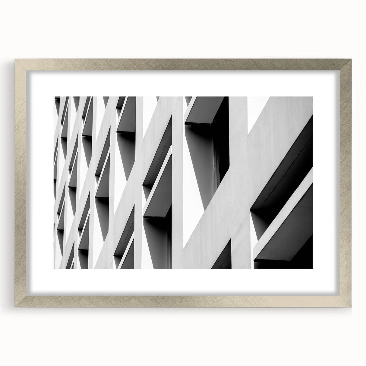 Abstract art print featuring swirling blue and white patterns on a silver-framed canvas.