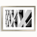 Abstract art print featuring swirling blue and white patterns on a silver-framed canvas.