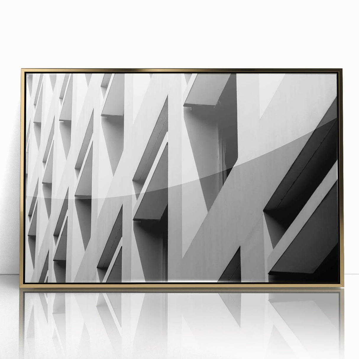 Mid-century modernist art featuring geometric shapes in gold and black on a framed acrylic print.