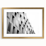 Textured abstract art print in neutral shades, displayed in a gold frame, ideal for bedroom wall decor.