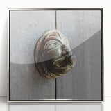 Mid-century modernist art depicting geometric shapes in muted earth tones on a framed acrylic print.
