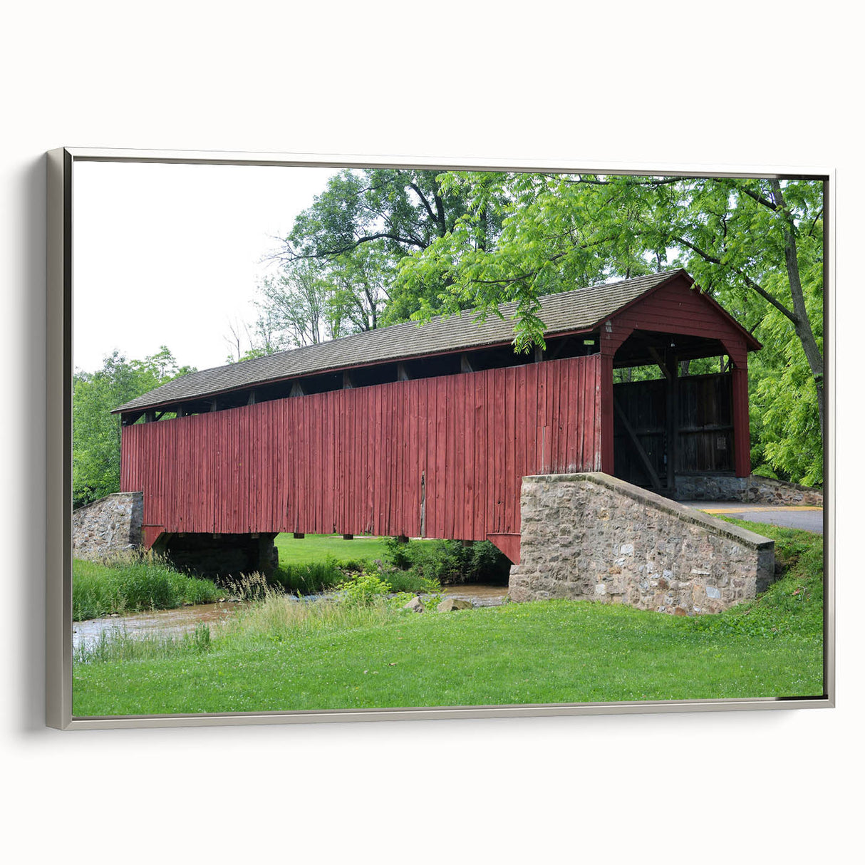 Landscape art painting of a serene lake, featuring muted green and blue tones on a framed canvas.