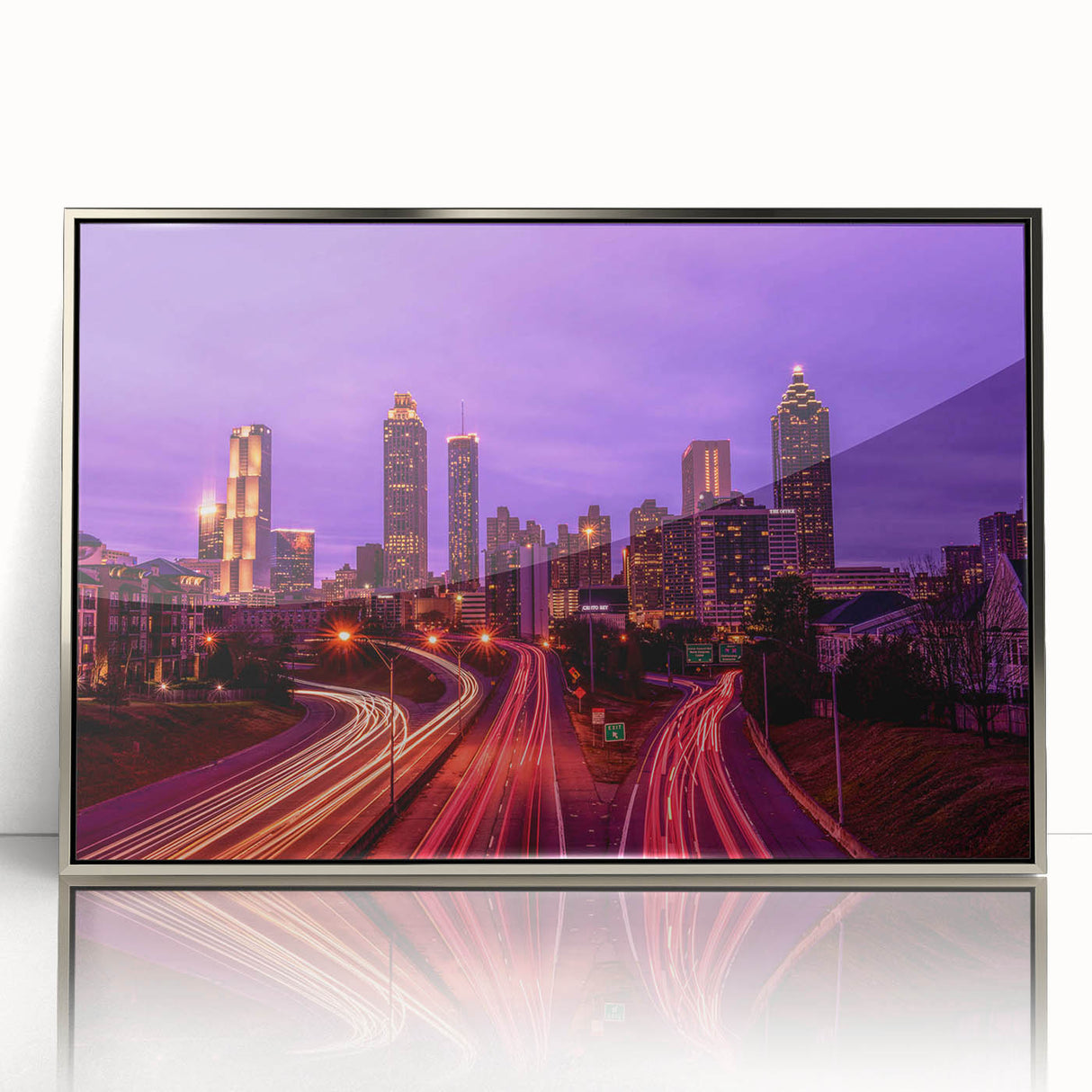 Art deco poster of a stylized cityscape in muted gray and blue tones, printed on framed canvas.