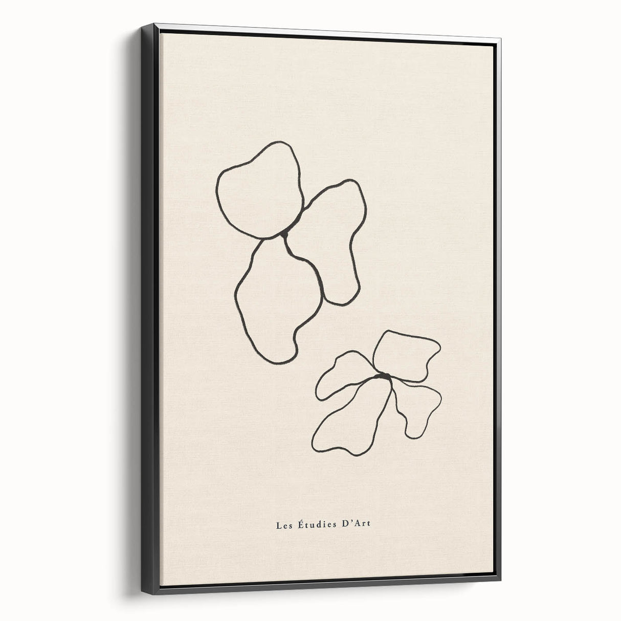 Framed minimalist black and white wall art piece showcasing abstract design elements, displayed in a modern living room setting with stylish decor.