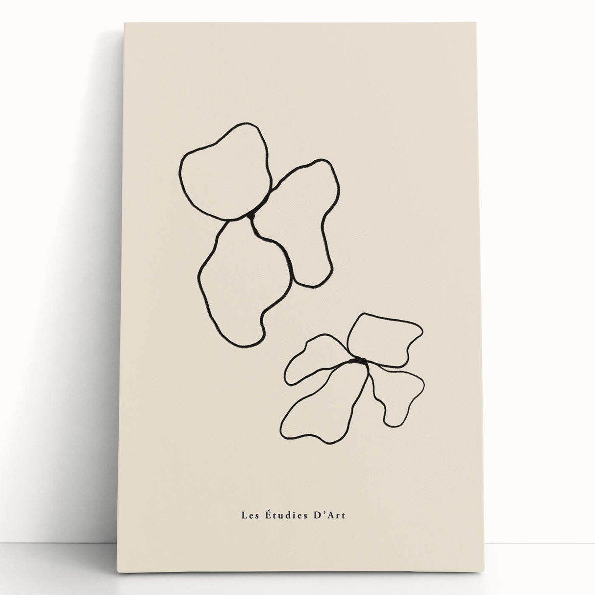 Abstract minimalist wall art collection featuring soft pastel colors on stretched canvas, leaning against a neutral-toned wall for a modern aesthetic.