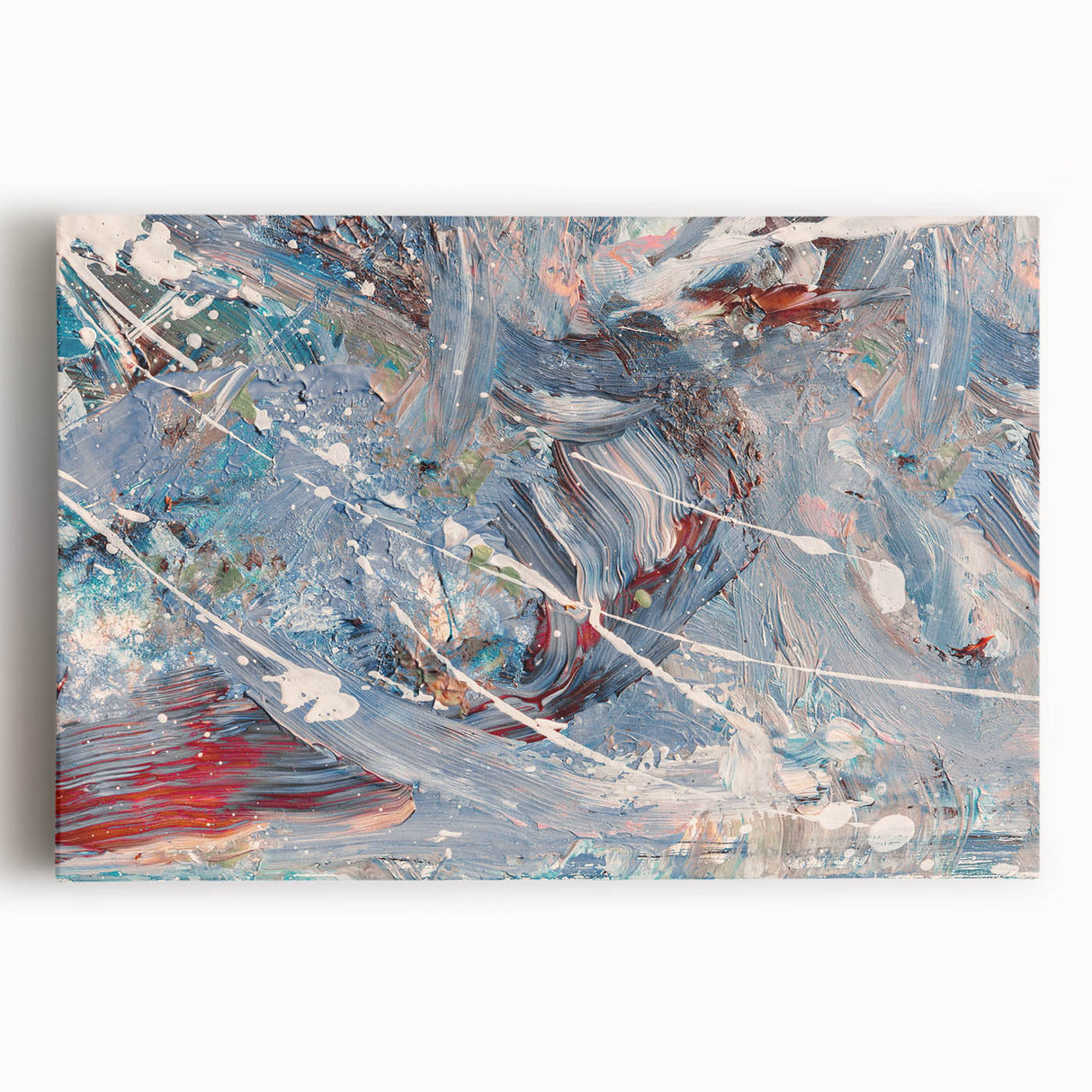 Colorful abstract splatter wall art on stretched canvas, showcasing vibrant hues of blue, orange, and yellow, ideal for modern home decor.