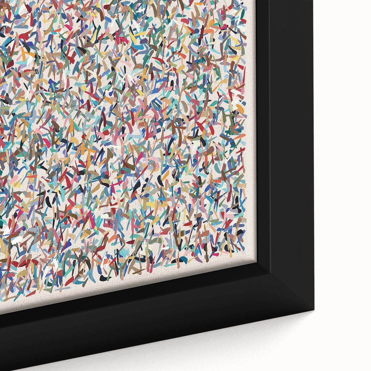 Close-up of an abstract wall art canvas featuring vibrant splatters in blue, red, and yellow, framed elegantly to enhance any modern decor.