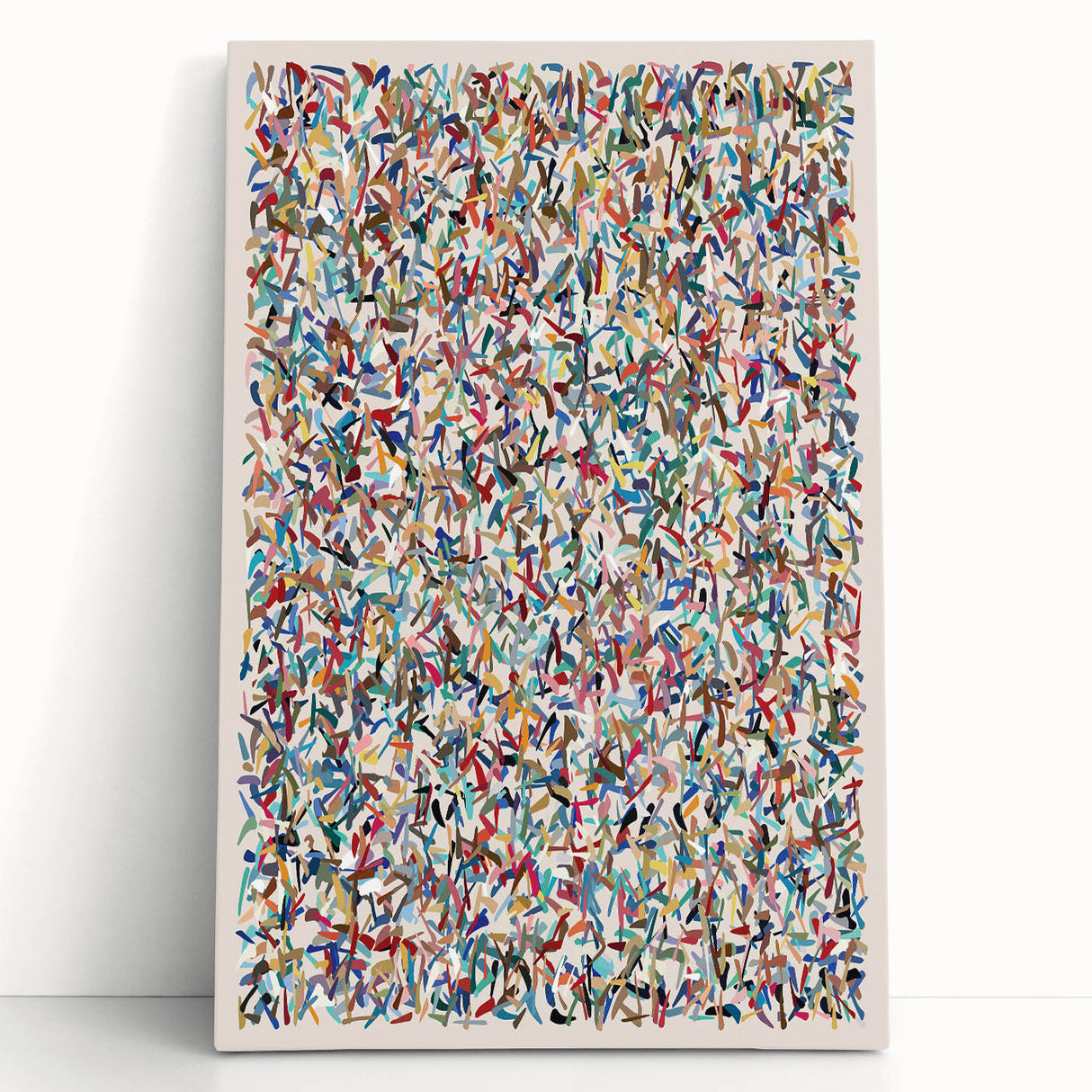 Abstract splatter wall art canvas featuring vibrant colors, leaning against a wall, perfect for modern home decor and artistic accents.