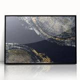 Framed wall art featuring an abstract design of colorful strokes and lines on a black background, adding a modern touch to any decor.