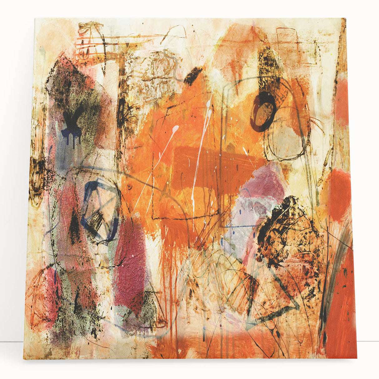 Abstract canvas wall art featuring vibrant strokes and lines in shades of blue, yellow, and red, leaning against a neutral wall, adding modern decor flair.