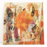 Abstract canvas wall art featuring vibrant strokes and lines in shades of blue, yellow, and red, leaning against a neutral wall, adding modern decor flair.
