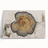 Abstract canvas wall art featuring vibrant strokes and lines in shades of blue, orange, and yellow, elegantly leaning against a textured wall, ideal for modern decor.